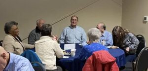 Bill talks with community members at local event.
